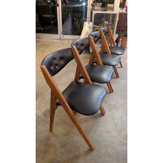 These are fantastic examples of Mid-Century Modern utility meeting high-end design. This set of four folding chairs is...