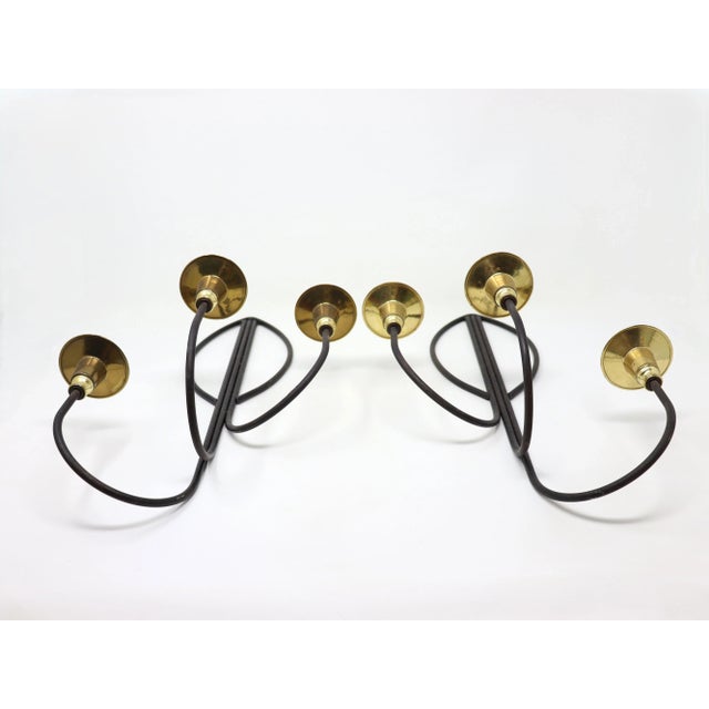 Pair of vintage high-style modernist iron wall candle sconces with brass holders. Fabulous design in the style of Tommi...