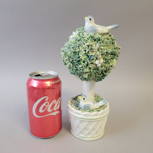 A sculptural Italian porcelain topiary featuring densely modeled foliage in layered shades of soft green and cream,...