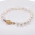 A fine vintage 18k gold & cultured pearl single strand bracelet. With 7 - 7.5 mm round white pearls with fine color and...