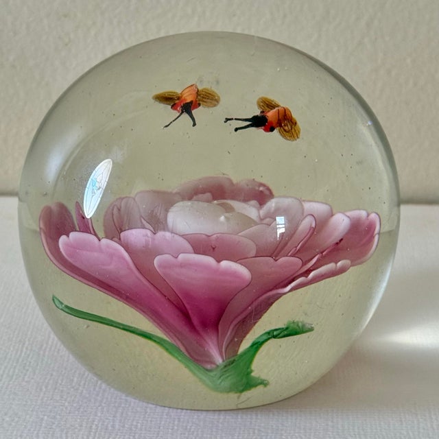 Beautiful and intriguing glass paperweight with pollinators appearing to fly suspended above a pink flower. Please see...