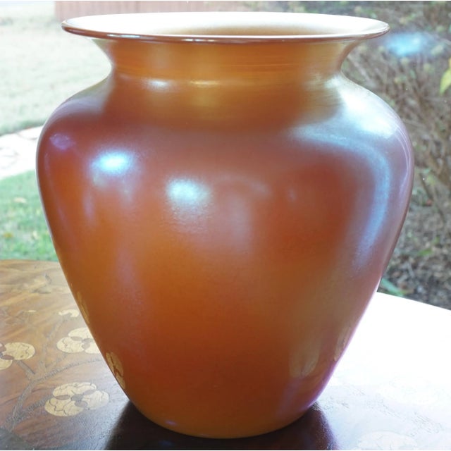 Durand Iridescent orange gold glass vase. With large beautiful proportions; this vase adds color and warmth to an...