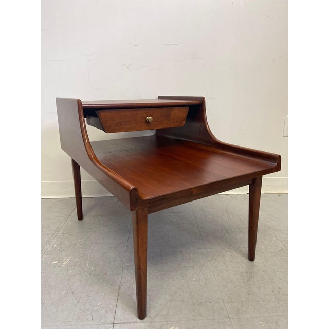 This End Table has beautiful sculpted wood Accents and walnut tone. Single dovetailed drawer with makers mark inside....