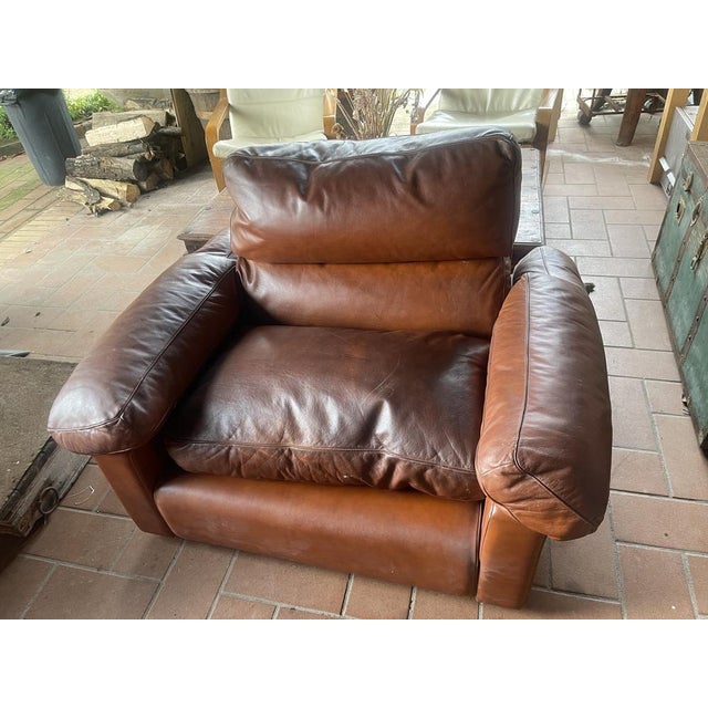 Frau Armchair in leather color cognac This armchair has a tear on the inside of the arm that is covered by the cushion and...