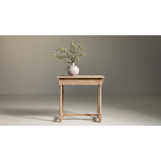 A distinguished example of 19th-century French craftsmanship, this oak side table embodies the understated elegance...