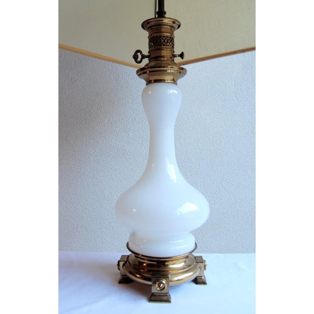 Opaque Murano milk glass and heavy brass French-style lamp. Adjustable finial feature. Shade not included. Original wiring...