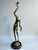 Striking modernist figural floor lamp featuring an elongated abstract human form rendered in heavily textured cast metal....