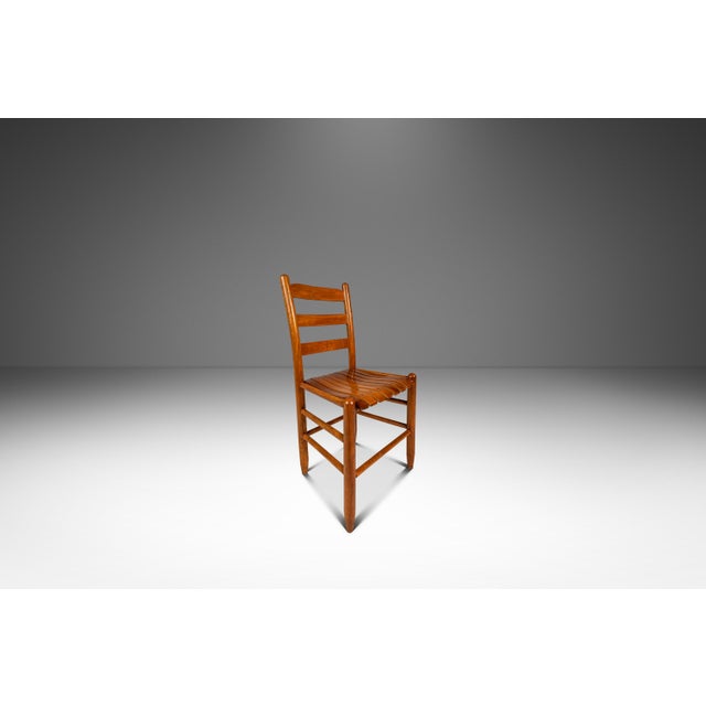 This handsome Mid-Century Modern armchair in solid oak captures the casual sophistication and honest materiality...
