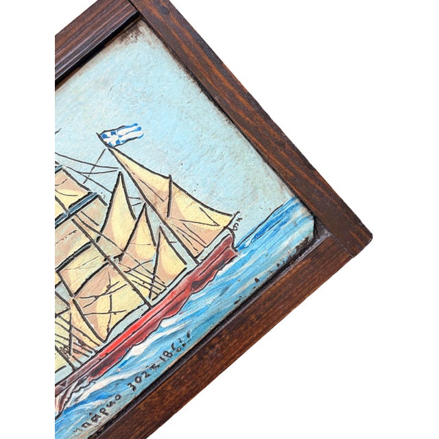 A vintage folk art ship painting, hand-painted on a carved wooden panel with a dark wood surround. The piece features a...