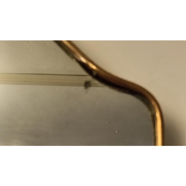 This elegant mid-century Italian wall mirror features a graceful arched silhouette, framed by a slender brass border that...