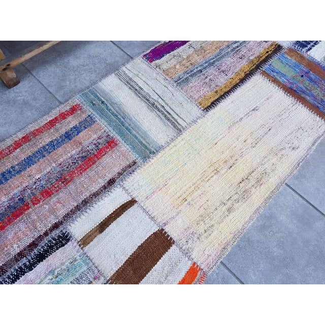 This is a vintage Turkish Oushak rug from the Mid 20th Century. The piece was hand-knotted.