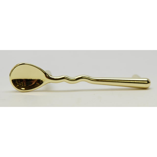 Spoon shaped cabinet or drawer pulls made of brass in polished finish. Mounting screws are included. Newly made by Knob...