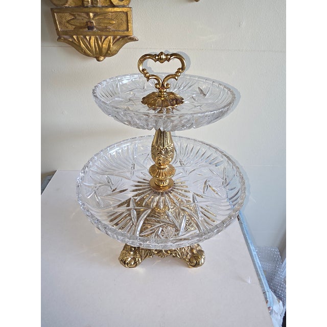 Tiered dessert stand or display stand. Gilt metal base and crystal surfaces.