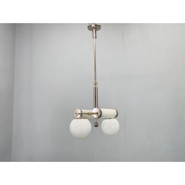 Exceptional Bauhaus chandelier from 1930s Czechoslovakia featuring a sophisticated composition of chrome-plated metal and...
