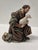 This Italian Baroque nativity sculpture represents a kneeling shepherd holding a small lamb close to his chest. The...