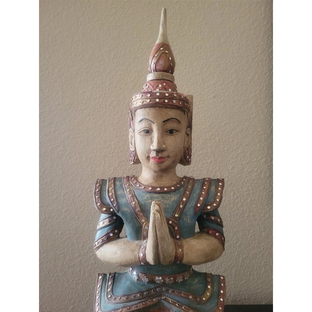 Unique piece depicting a Thai Goddess carved in wood and polychrome hand painted, her head piece and dress is adorned with...