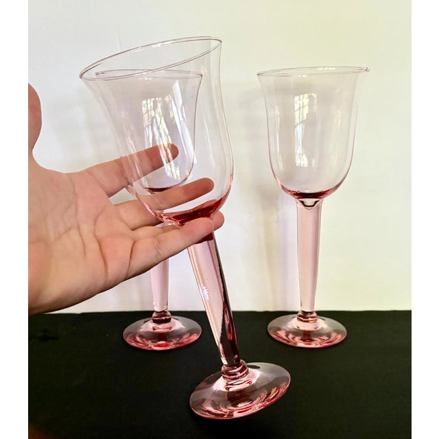 Exquisite set of three tall blush pink water goblets, each soaring at 8 3/4″ tall. These sturdy goblets feature thick,...