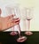 Exquisite set of three tall blush pink water goblets, each soaring at 8 3/4″ tall. These sturdy goblets feature thick,...