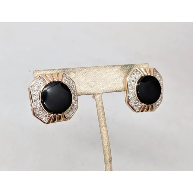 1980s goldtone octagonal round flat faux-onyx center with pavé round clear rhinestones on either side pierced earrings...