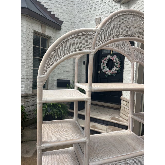 Offered is a one piece vintage wicker and bamboo etagere. This piece features the original finish with double doors that...