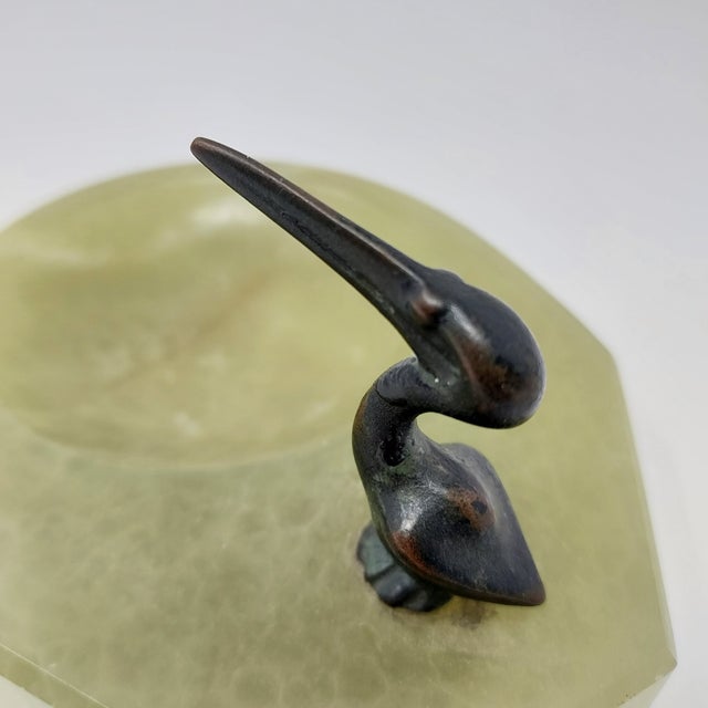 Pale green onyx catchall with bronze pelican figurine. 5.25" x 4.25" x 1".