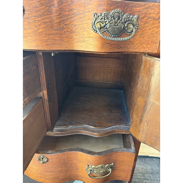 Antique oak highboy dresser featuring distinctive serpentine bowed drawers and a small upper side cabinet. Excellent...