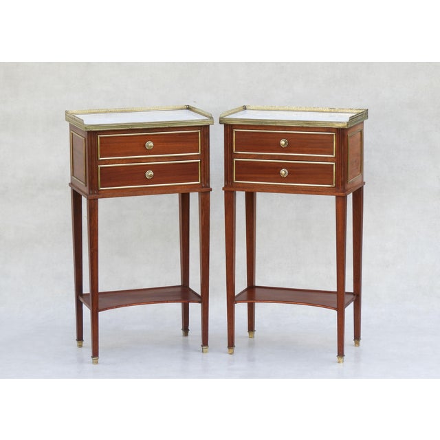 Pair of Louis XVI Revival Nightstands, C1950s France. Classic Louis XVI style two drawer bedside tables with marbled tops,...