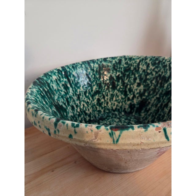 The speckled green drip glaze pooling over the rim of this Italian tian bowl is the kind of surface that takes decades to...