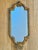 This Florentine wall mirror was handcrafted in Italy and dates to approximately the mid-20th century. The slender giltwood...