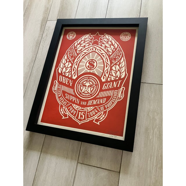 A very nice framed Original Screen Print of 'Obey Giant, Supply & Demand in Red' by Shepard Fairey. The print is signed,...