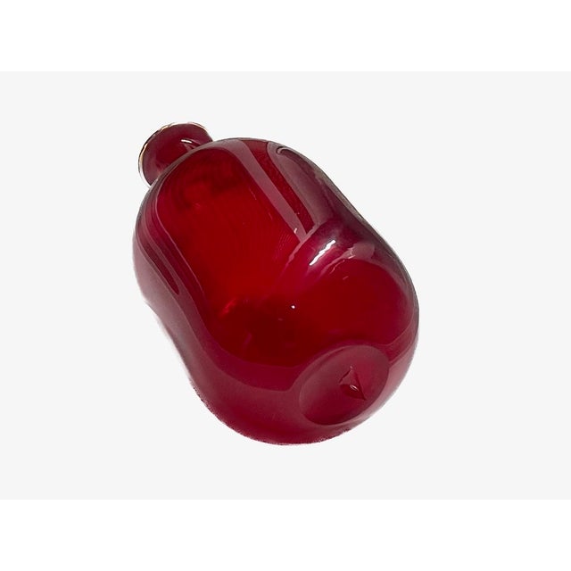 A superb example of Mid-Century Modern American art glass, this ruby red "Primitive" decanter is the Blenko #920 design,...