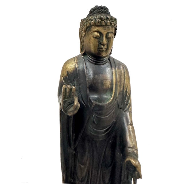 This statue of Amida (Sanskrit Amitabha Buddha), the Buddha of the Western Paradise, performs the gesture of teaching...