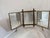 This is an antique triptych dressing mirror in the Aesthetic Movement taste, with a faux-bamboo styled bronze frame and...