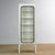 Vintage medical cabinet from the 1970s, made in Hungary. The cabinet is made of iron and glass, with the glass clamped to...