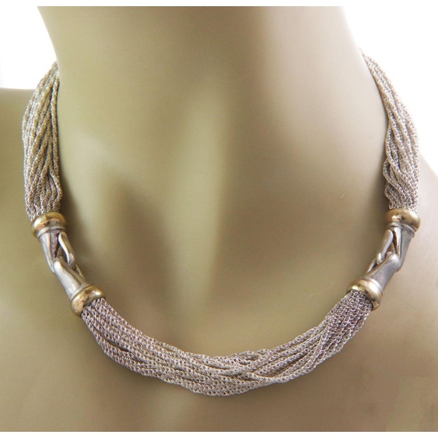 This is an authentic vintage multi strand chain necklace from Tiffany & Co. It is crafted from sterling silver and 14k...