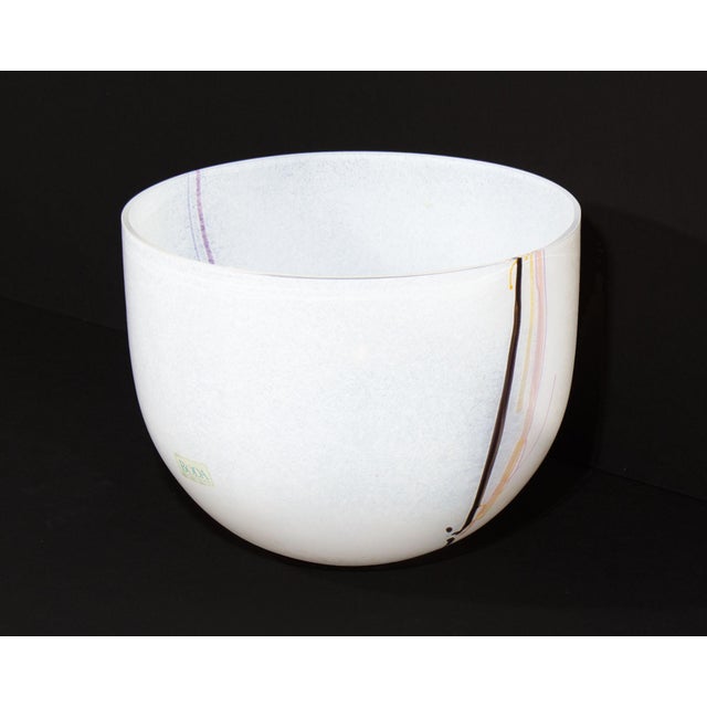 A glass "Rainbow" bowl designe by the Swedish glass artist Bertil Vallien (born 1938) for Kosta Boda. This primarily white...