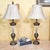 Elegant matched pair of vintage lead crystal table lamps featuring tall fluted crystal columns, urn-form metal accents and...