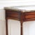 This exquisite French console table dates from the late 19th century and impresses with its original white marble top and...