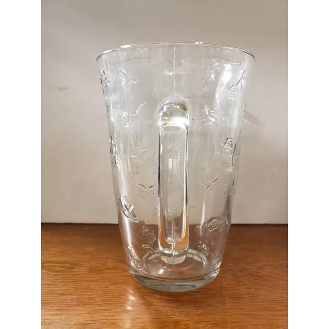 This is a Vintage Anchor Hocking Clear Glass Pitcher with Floral Motif. It measures 9 3/4" high and 6“ in diameter at the...