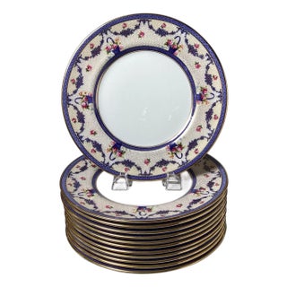 A set of twelve dinner plates by Royal Doulton, a renowned English ceramic mfg. For Sale