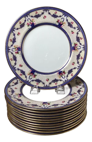 A set of twelve dinner plates by Royal Doulton, a renowned English ceramic mfg.