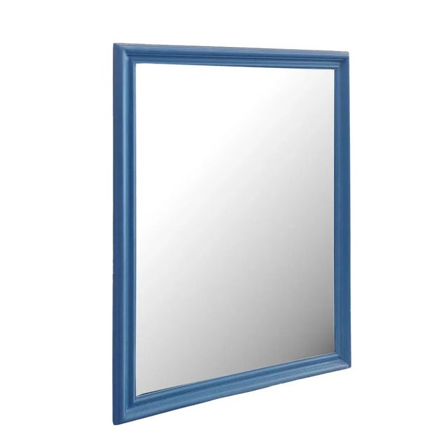 Vintage mirror with newly painted wooden frame in blue color. The mirror has spots and marks thats give it the charm of...