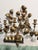 A dramatic oversized vintage wall candelabra with sculptural metal leaves, vine-like branches, and an antiqued gold...