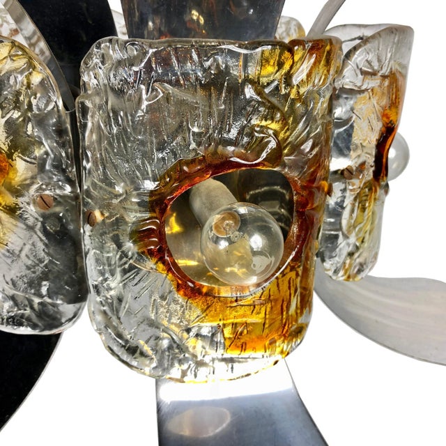 This chandelier by the Italian designer Mazzega (circa 1970) has a chromed metal construction and five Murano glass light...