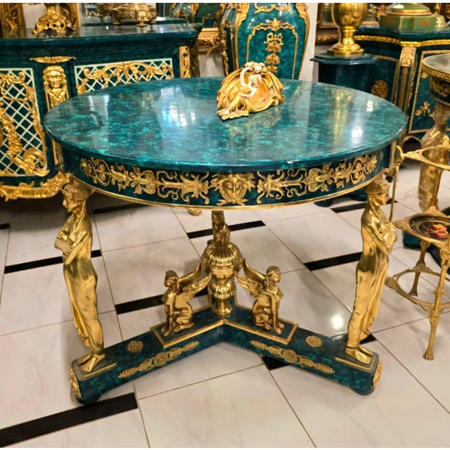 Make an unforgettable statement with this extraordinary French Empire Center Table, masterfully crafted in a rich bottle...