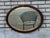 Beautiful antique Victorian oval wall mirror with a solid oak frame and original beveled edge glass. Features attractive...