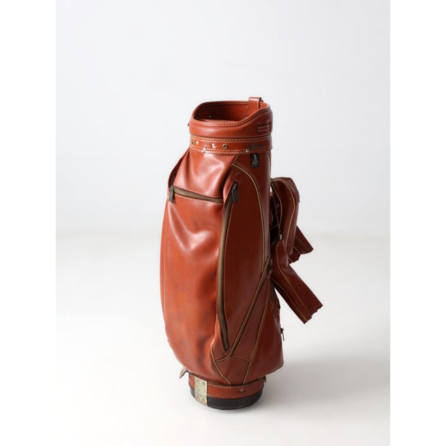A vintage golf bag by AMF in collaboration with Ben Hogan, rendered in a rich saddle tone and finished with contrast...