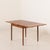 Danish vintage mid-century square teak extension table. It features two additional pull-out leaves that hide under the...
