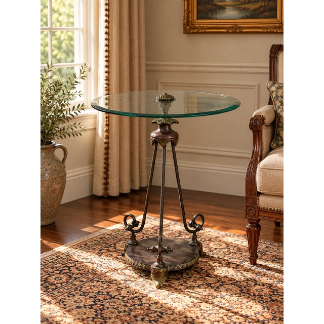 This vintage verdigris bronze neoclassical style glass end table draws inspiration from classical tripod forms, combining...