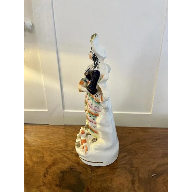 Antique Victorian Staffordshire flatback figure of a lady playing a harmonica with her dog at her feet. H 28 x W 12 x D...